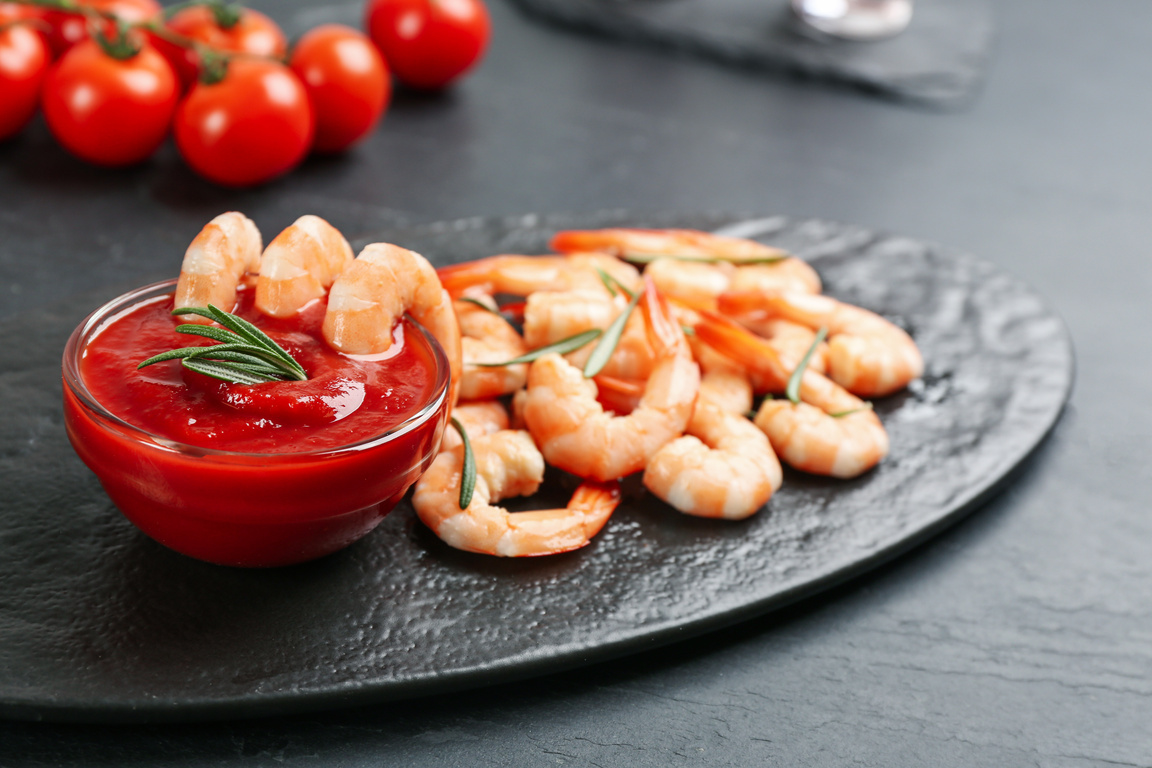 Delicious Shrimp Cocktail with Tomato Sauce Served on Black Table